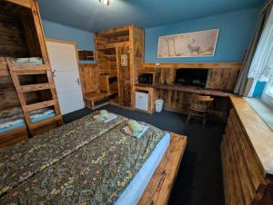 a bedroom with a bed in a room with wooden walls at Planinski dom Janče in Ljubljana