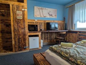 a hotel room with a bed and a tv at Planinski dom Janče in Ljubljana