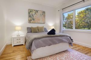 a bedroom with a large bed and a window at Delightful Digs on David in Albury