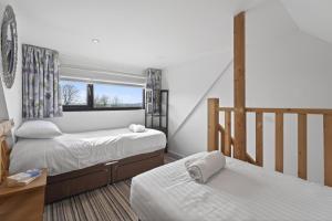 a bedroom with two beds and a window at 1 Bed in Alkham oc-s34788 in Swingfield