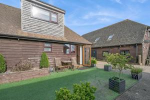 a backyard with a table and chairs and a house at 1 Bed in Alkham oc-s34788 in Swingfield +11 photos