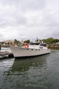 a white boat is docked in the water at Classic Seadream Yacht in Figueira da Foz