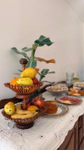 a table with plates of fruit on top of it at Amoite hotel boutique in Nuestra Señora del Rosario de Caa Catí