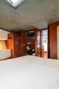 a bedroom with a bed and wooden cabinets at Classic Seadream Yacht in Figueira da Foz
