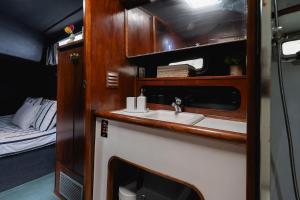 a bathroom with a sink and a bed at Classic Seadream Yacht in Figueira da Foz +11 photos
