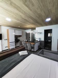 a large kitchen and living room with a table at New Time 304 Maceió Alagoas in Maceió