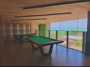 a room with two ping pong tables in a room at New Time 304 Maceió Alagoas in Maceió
