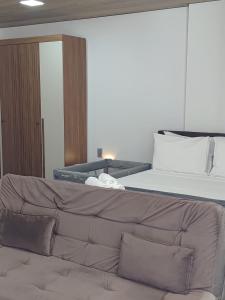 a bed and a couch in a room at New Time 304 Maceió Alagoas in Maceió +65 photos