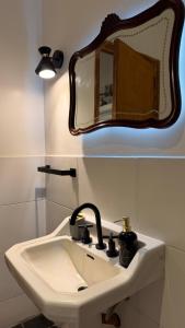 a bathroom with a sink and a mirror on the wall at Amoite hotel boutique in Nuestra Señora del Rosario de Caa Catí