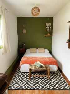 a bedroom with a bed and a table in it at Onda Verde Hostel in San Salvador de Jujuy +52 photos