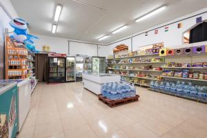 a store aisle with bottles of water on shelves at Casa Nube in Corralejo