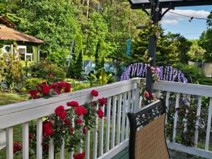 a white fence with red flowers on it at vacation paradise in Ararat