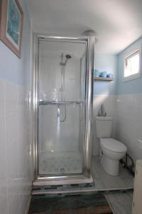 a shower in a bathroom with a toilet at Sheppey Village Ollie in Leysdown-on-Sea +10 photos
