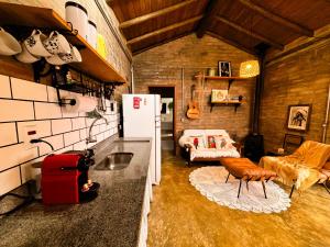 a living room with a refrigerator and a couch at Sítio Passarim in São Francisco Xavier