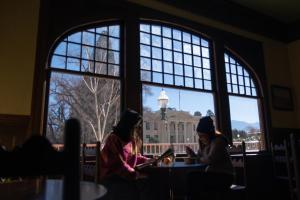 two women sitting at a table looking out of a window at Winnedumah Hotel in Independence +54 photos