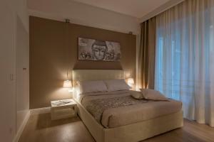 Postel nebo postele na pokoji v ubytování Aruna Suites