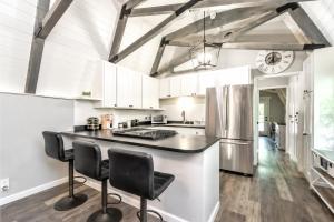 a kitchen with a black counter and a refrigerator at Secluded River Cabin Near Sly Park & Apple Hill in Placerville