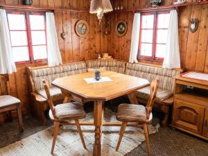 a dining room with a wooden table and chairs at Almhütte Seebergalm in Seewiesen +18 photos