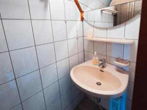a white bathroom with a sink and a mirror at Almhütte Seebergalm in Seewiesen