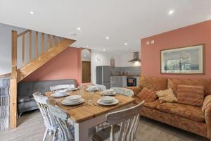 a kitchen and living room with a wooden table and chairs at 2 Bed in Alkham oc-v34789 in Swingfield +35 photos