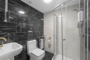 a black tiled bathroom with a toilet and a sink at 2 Bed in Alkham oc-v34789 in Swingfield