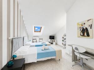 a bedroom with a bed and a desk in it at Cà di Lilly - Attic Suite AC Wi-Fi in Vado Ligure