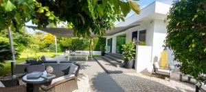 a patio of a house with a couch and chairs at Mondello Luxury villa in Palermo