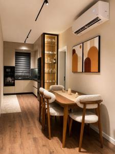 a dining room with a wooden table and chairs at L olive Villa in Zogaji
