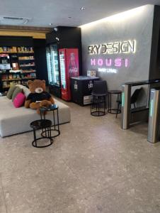 a teddy bear sitting on a couch in a store at Sky Design Alphaville Hotel Residence in Barueri +42 photos