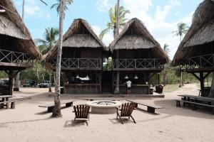 a person standing in front of a building with a fountain at UNÚ Beach Hotel in Palomino