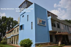 a blue building in front of a building at Hotel O Royal Stay in Bangalore +27 photos