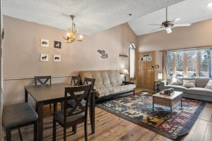 a living room with a table and a couch at Pine Acres 109 - Hideaway in Durango