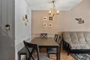 a dining room with a table and a couch at Pine Acres 109 - Hideaway in Durango