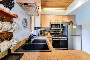 a kitchen with a sink and a stainless steel refrigerator at Pine Acres 109 - Hideaway in Durango