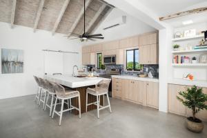 a kitchen with a large island with bar stools at Opaline Villa 4BR 2Bath-Ocean Front in Providenciales