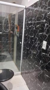 a spider web on the wall of a bathroom at Vivendas Raízes do forte in Praia do Forte