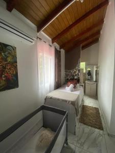 a bedroom with two beds in a room with a window at VillaBadlou "Lodge Ti-Kaco Vanille" in Trois-Rivières +83 photos