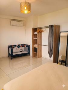 a living room with a bed in a room at Location meublee Kourou pour 5 personnes plus 1 bebe in Kourou