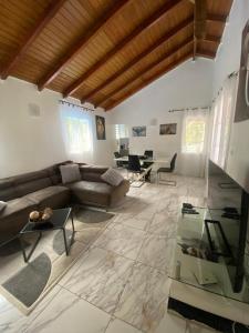a living room with a couch and a table at VillaBadlou "Lodge Ti-Kaco Vanille" in Trois-Rivières