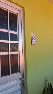 a door to a building with a sign on it at Vivendas Raízes do forte in Praia do Forte