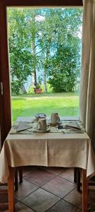 a table with two tea pots on it in front of a window at Affittacamere I Picchi in Gressan