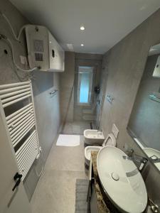 a bathroom with two sinks and two toilets at Modern Lake Apartment Tirana - Quiet Stay near Liqeni i Thatë in Tirana