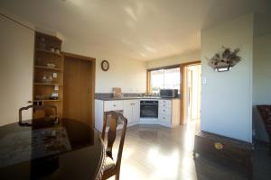 a kitchen with a table and a dining room at Annie's in Methven +11 photos