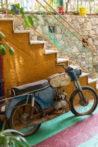 an old motorcycle parked next to a staircase at Erofili Rooms in Agia Galini