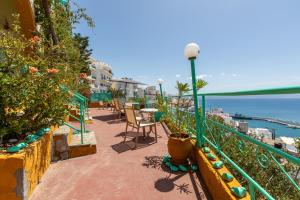 a balcony with a table and chairs and the ocean at Erofili Rooms in Agia Galini