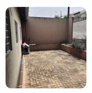 an empty patio with a fence and a building at Raquel in Londrina