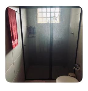 a bathroom with a glass shower with a toilet at Raquel in Londrina +12 photos