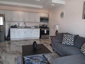 a living room with a couch and a kitchen at Prospect Loft in Kingstown
