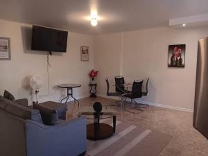 a living room with a couch and chairs and a table at Prospect Loft in Kingstown