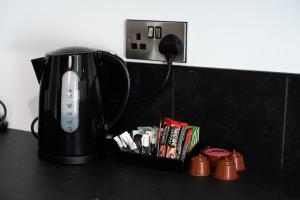 a black coffee pot sitting on a counter next to a outlet at Self-Contained Studio Private Bathroom Sleeps 2 in Nottingham